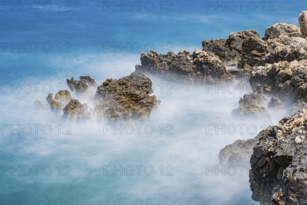 Romantic view over the sea in Koromacna Bay on a sunny day with rough seas on the island of Cres, long exposure, Croatia