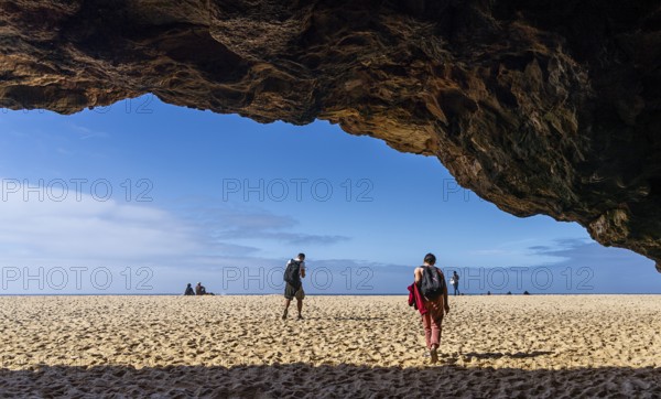 Tourists watch the waves of the Atlantic on the rocky plateau of Sito, also known as Forte São Miguel, a surfing paradise with monster waves in the months of November to February, Nazaré, Portugal