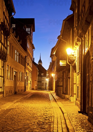 Half-timbered houses in a narrow street with cobblestones, Old Town in the evening, World Heritage City of Quedlinburg, Saxony-Anhalt, Germany