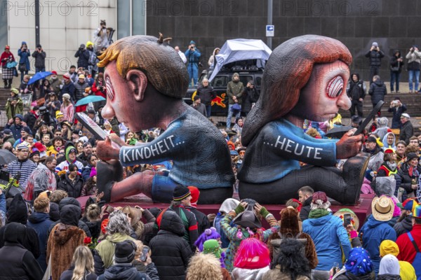 Rose Monday procession in Düsseldorf, theme car by wagon manufacturer Jacques Tilly, topic of smartphone addiction among children and adolescents, North Rhine-Westphalia, Germany