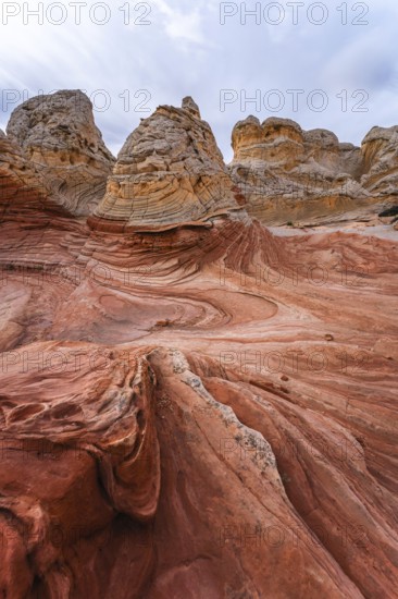 Striking view of the swirling red and beige rock formations of White Pocket, located in Arizona's remote desert landscapes