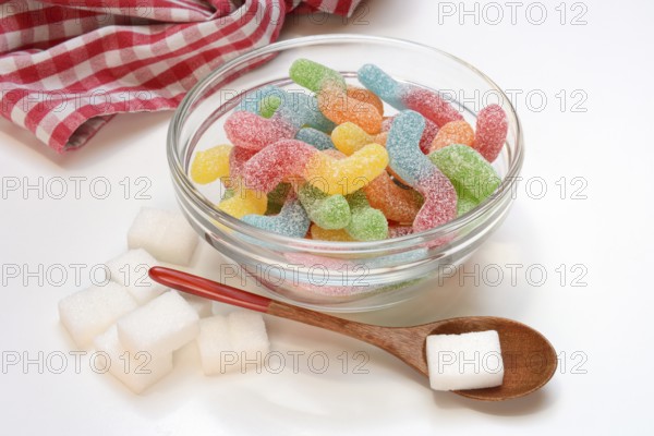 Lots of colorful jelly candies and sugar cubes, sugar consumption