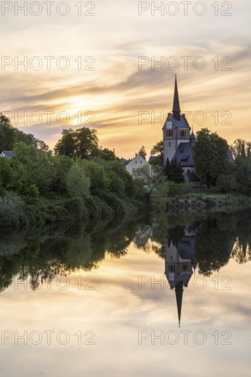 St. Pancratius Church in the evening with reflection in the Freiberger Mulde, Tragnitz, Leisnig, Saxony, Germany