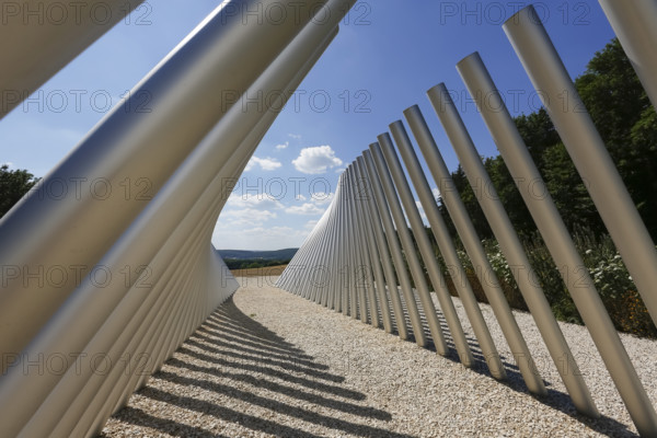 Art in public space, sculpture made of aluminum profile pipes by artist Martin Burchard, life's horizon path near Mundingen, light and shadow, gravel, clouds, blue sky, walk-in art, paths of reflection and refreshment on the Ehinger Alb, Baden-Württemberg, Germany