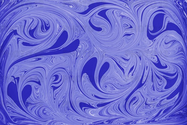 This image showcases an abstract floral pattern of swirling blue and white acrylic paint, reminiscent of marble. The fluid motion and intricate design create a mesmerizing visual effect