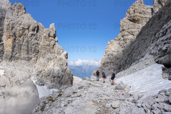 Three mountaineers in the mountains, Via Ferrate Benini Via Ferrate, Brenta Mountains, Brenta-Adamello Natural Park, Trentino, Italy