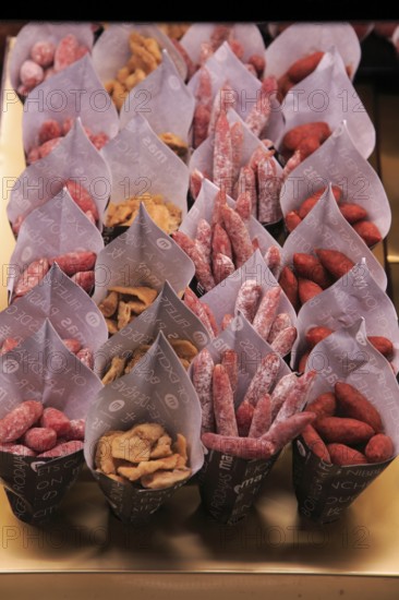 Small sausages packed for sale, Mercado San Miguel market, Madrid city centre, Spain