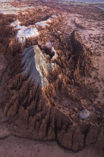 Stunning aerial capture of the unique geological formations of Goblin Valley State Park in Utah, displaying a contrast of rugged textures and colors
