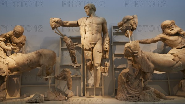God Apollo in the middle, west pediment of the Temple of Zeus, battle between lapiths and centaurs, mythological scene in ancient Greek marble sculptures with central male figure, Olympia Archaeological Museum, Ancient Olympia, Olympia, Peloponnese, Greece