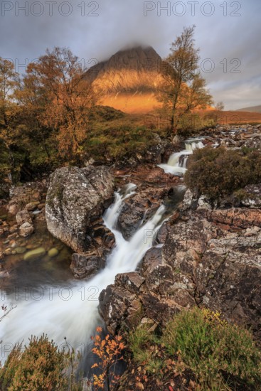 Wild river, waterfall, autumn colours, morning light, mountain landscape, cloudy mood, Buachaille Etive Mòr, Glencoe, Scottish Highlands, Scotland, Great Britain