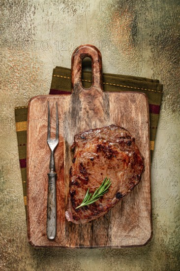 Grilled steak, beef steak, rib eye steak, on a chopping board, top view, no people