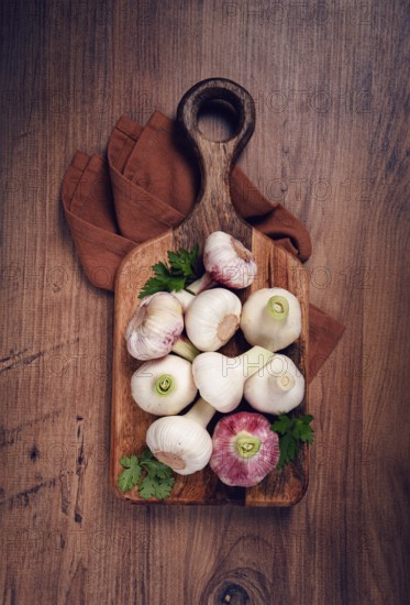 Fresh young garlic, white and purple color, on a wooden table, no people