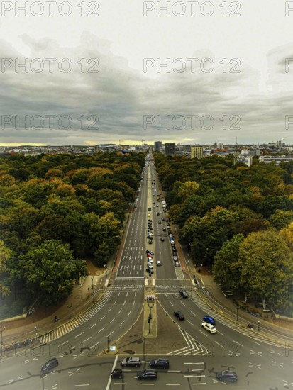 Street in the city surrounded by autumn trees, houses on Hoirzont under cloudy sky, view from Victory Column, Berlin