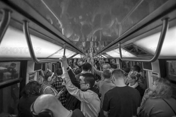 Full metro at rush hour, black and white, Paris, France