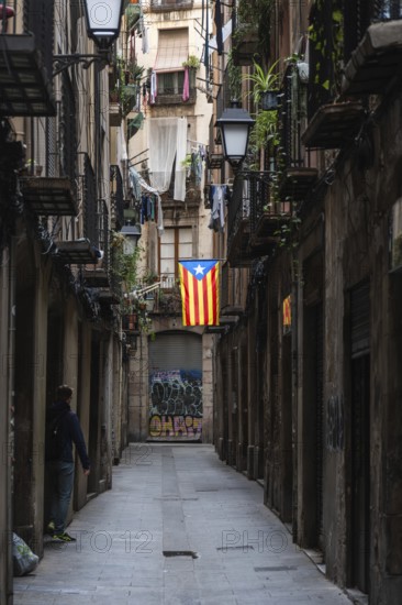 A flag of the Estelada of the Catalan Nationalists in an alley of the historic centre of Barcelona, Spain