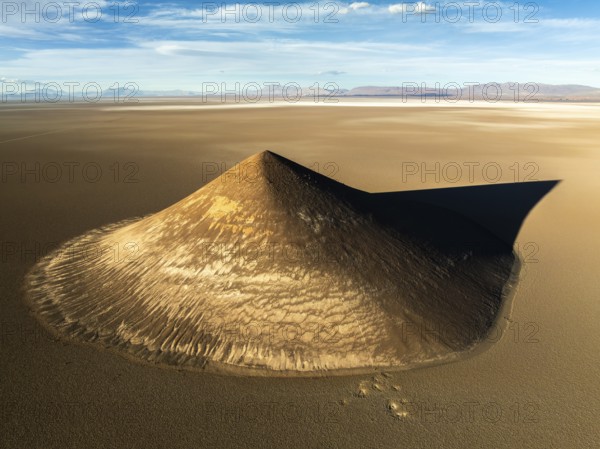 From above, this aerial shot captures the stunning Cono de Arita, a natural volcanic cone located in the remote puna region of Salta, Argentina