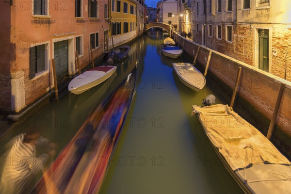 Evening gondola ride on a side canal in the Dorsoduro district, Venice, Veneto, Italy