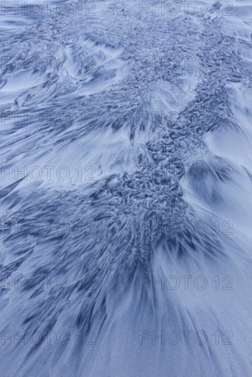 Patterns in the sea sand at beach along the coast in winter