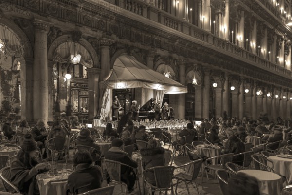 Music orchestra playing in front of the historic Café Florian on St. Mark's Square in the evening, Venice, Veneto, Italy