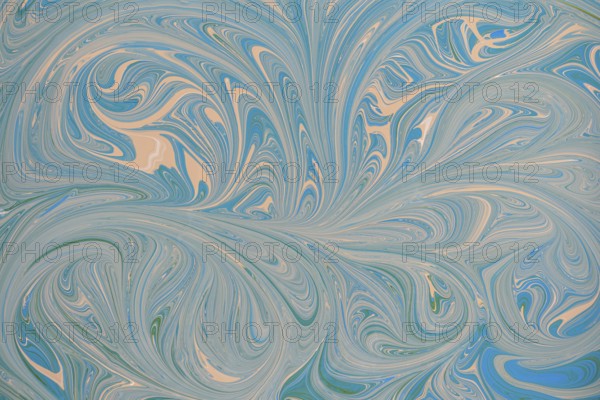 An abstract floral pattern with swirling blue and beige acrylic paint. This dynamic design creates a sense of movement and fluidity, perfect for backgrounds or creative projects