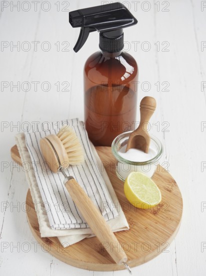 Natural cleaning products. Liquid cleaner in glass spray bottle, lemon and baking soda. Reusable brush and cotton cloths. Environmentally friendly. Zero waste concept. Plastic free