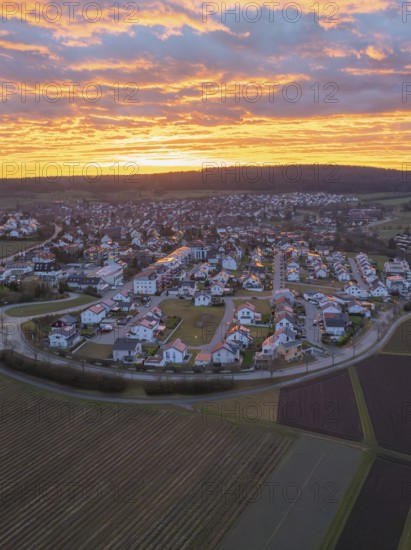 Overview of a town in twilight with a sky in golden tones and cloud formations, aerial view, Calw Stammheim, Black Forest, Germany
