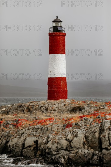 Lighthouse on a rocky island in the sea under a stormy sky, The lighthouse in the Beagle Channel near Ushuaia in Argentina