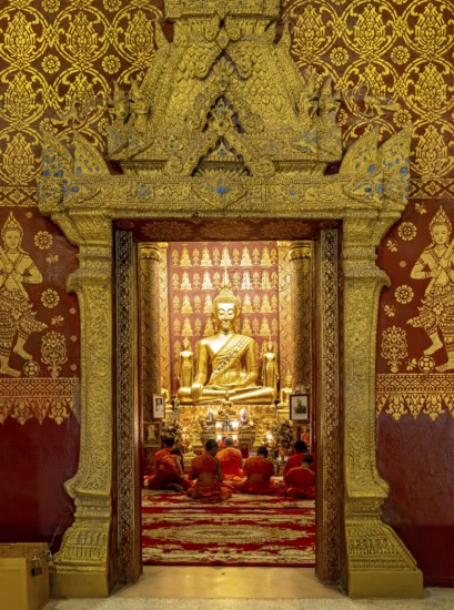 Monks praying at Wat Sensoukharam, Luang Prabang, Laos