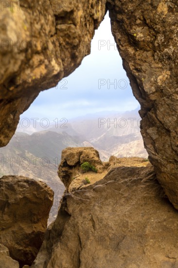 Roque nublo volcanic rock formations framing a scenic mountain view during a hike in gran canaria, spain
