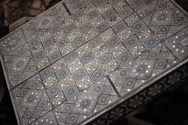 Damascus, Syria. December 10th 2025. Close-up detail of a handmade mosaic wooden backgammon box inside the workshop of Syrian artisan Abu Toni, Bab Touma, Damascus, Syria