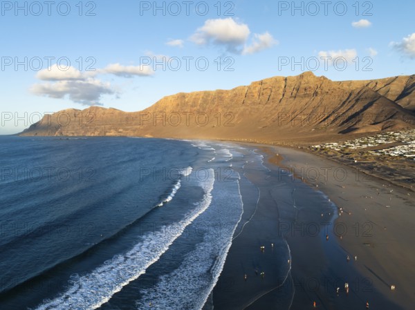 Risco de Famara cliffs and sea with Famara beach, in the evening light, Playa de Famara, aerial view, Lanzarote, Canary Islands, Spain