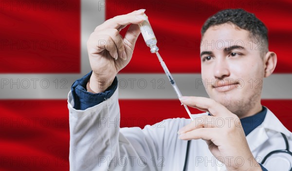 Doctor holding syringe on Denmark flag background. Medical professional holding syringe with Danish flag in the background