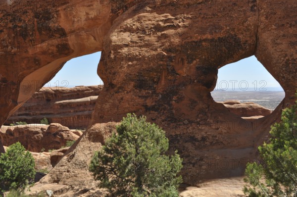 Sandstone formations with double windows offer spectacular views of the desert, Arches National Park, Utah, USA
