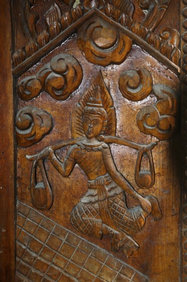 Temple door decorated with wood carvings in Buddhist monastery complex Buddhist temple complex Wat Sri Sunthon, Phuket Island, Thailand