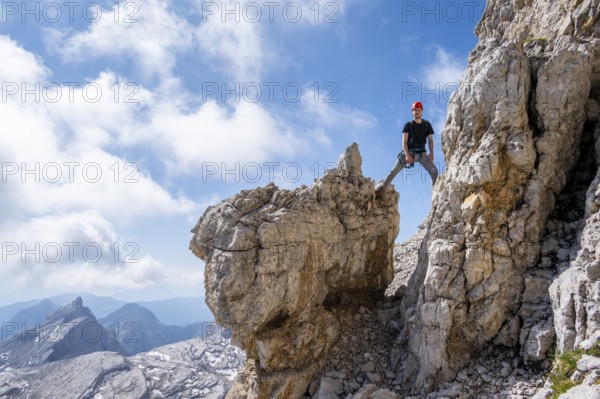 Mountaineer standing on a rock, Via Ferrate Benini via Ferrate, Brenta Mountains, Brenta-Adamello Natural Park, Trentino, Italy