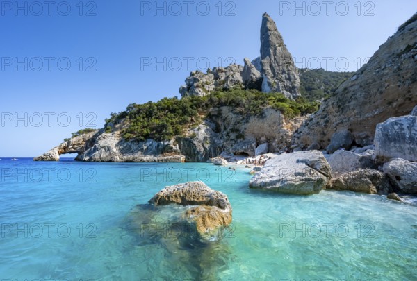 Light blue clear sea on a dream beach on Cala Goloritzé, picturesque rocky coast, steep coast with rock pin L'Aguglia, Golfo di Orosei, Baunei, Sardinia, Italy