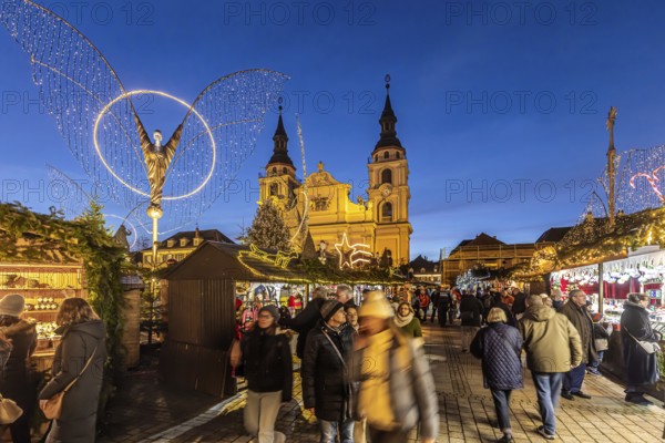 Baroque Christmas market with illuminated angels between the Protestant City Church and the Catholic Church of the Most Holy Trinity. Sights on the market square in the evening. Ludwigsburg, Baden-Württemberg, Germany