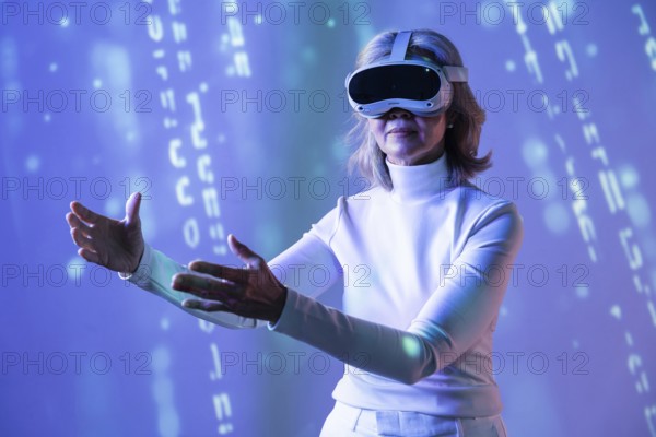 An elderly Asian woman in a white turtleneck enjoys an immersive experience in the metaverse, wearing a VR headset. She extends her arms as if interacting with a virtual world