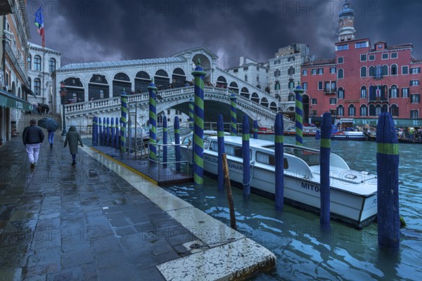 Rain clouds over the Rialto Bridge, a police boat anchored in front, Venice, Veneto, Italy