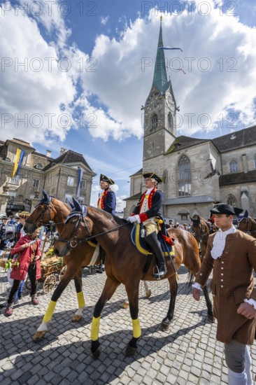 Historically costumed guild members in Zurich's old town, riders in front of the Fraumünster church, Zunft zur Meisen, Sechseläuten or Sächsilüüte, Zurich Spring Festival, Zurich, Switzerland
