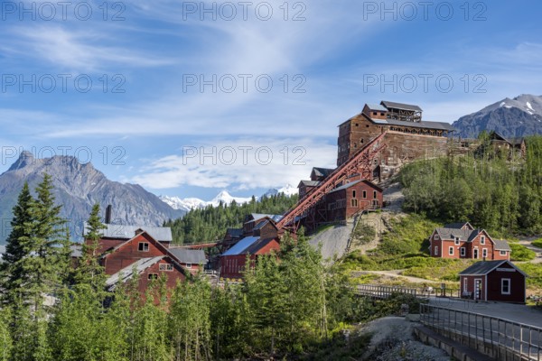Red Kennicott buildings in front of mountainous landscape, Kennicott Concentration Mill to extract copper from quarried rock, Historic Kennecott Copper Mine, National Historic Landmark, Wrangell St. Elias National Park, Alaska, USA
