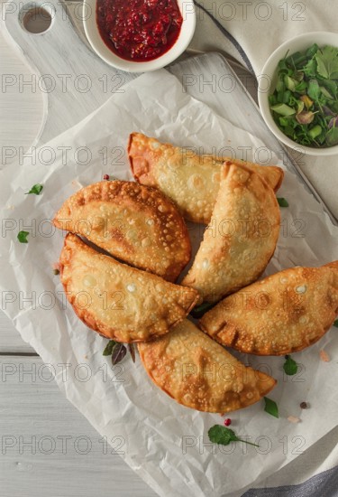 Fried chebureks, close-up, on a light background, no people