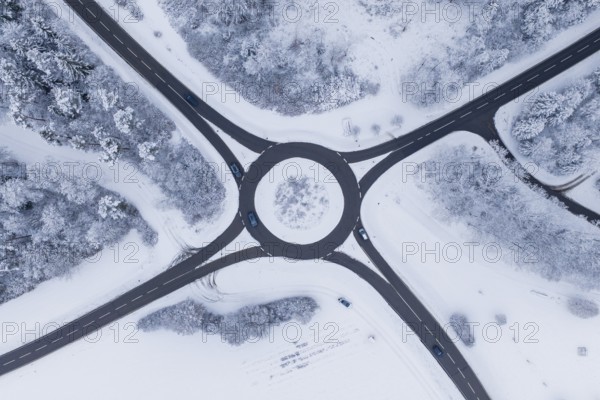 Aerial view of a snowy roundabout surrounded by trees, Gechingen, Calw district, Germany