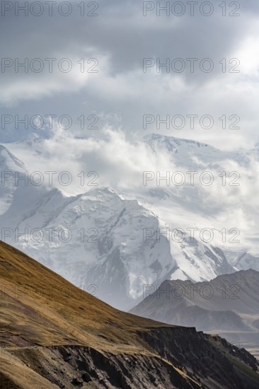 Dramatic mountain landscape, mountain valley, behind glaciated and snow-covered mountain peak Pik Lenin, Trans Alay Mountains, Pamir Mountains, Osh Province, Kyrgyzstan