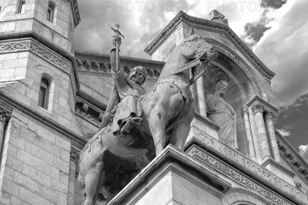 Equestrian statue of King Saint Louis in front of the Sacré-Cœur de Montmartre, black and white, Paris, France