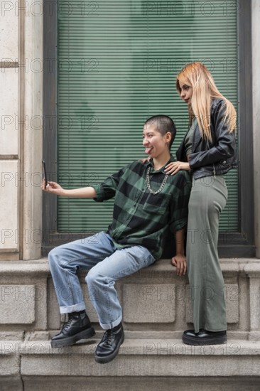 A Colombian lesbian couple enjoys a day out, capturing joyful moments together. Embracing love, identity, and diversity, they stand as a representation of LGBTQIA+ pride