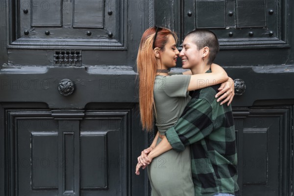 A Colombian lesbian couple lovingly embraces, symbolizing unity and diversity. Their affectionate gesture highlights the essence of love, equality, and LGBTQIA+ pride