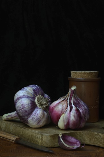 Fresh red garlic on chopping board, France