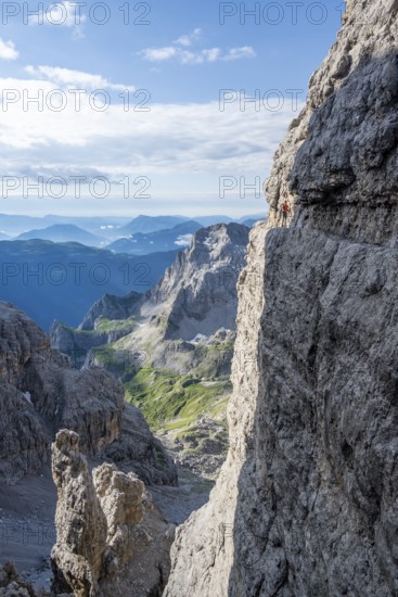 Climbers on a rock band, Bocchette Centrale band trail, via ferrata in the Brenta Mountains, Brenta-Adamello Natural Park, Trentino, Italy