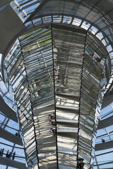 Interior view of the glass dome with mirrored surfaces and people, Reichstag building, German Bundestag, Berlin, Germany